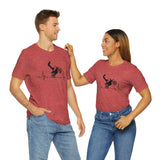 Male and female models wearing Heather red shirt displaying image of person on dirt bike riding a heartbeat line